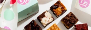 An assortment of gourmet brownies in various flavors, elegantly packaged.