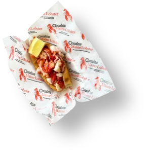 Lobster roll on branded Cousins Maine Lobster wrapping paper.