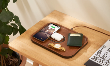 A stylish charging tray designed to charge a smartwatch, phone, and AirPods all in one place, showcasing a sleek and functional tech accessory