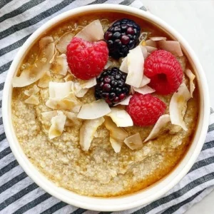 Bowl of oatmeal topped with raspberries